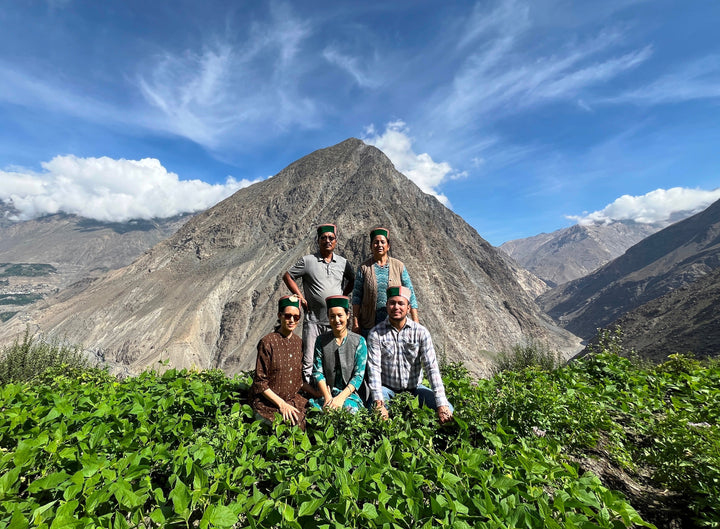 Guruson’s Family Apple Farm in Upper Kinnaur – family in apple orchard with hills